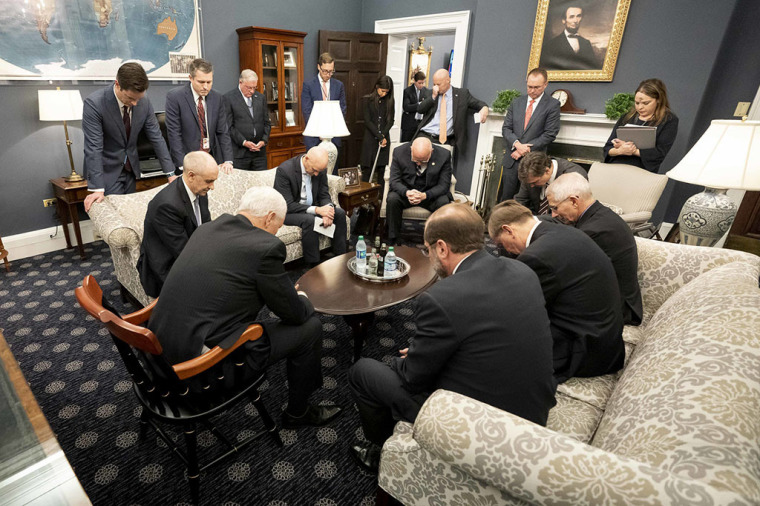 Vice President Mike Pence prays with the White House Coronavirus task force, Feb 26, 2020.
