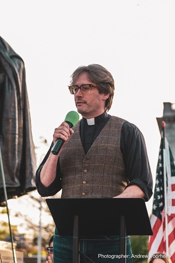 Rev. Jason Wells leads prayer at the May Day 2025 event